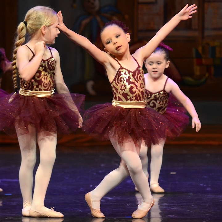Three girls dancing ballet.