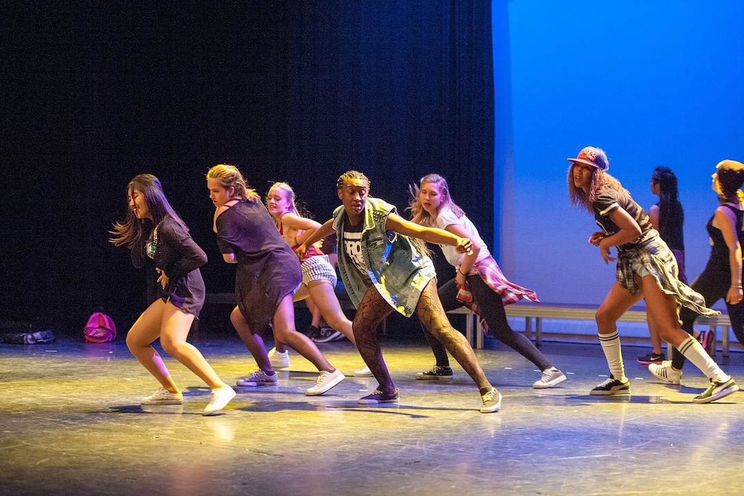 Group of teenagers performing hip-hop dance.