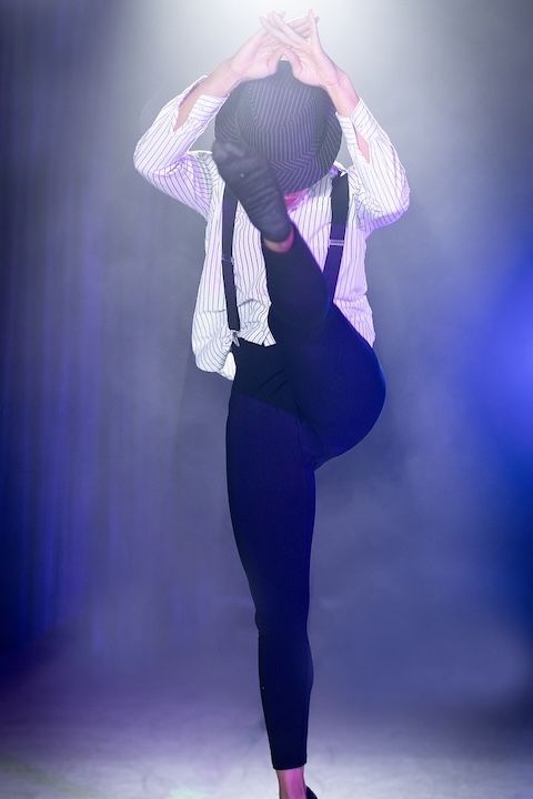 Jazz dancer kicks in the air.